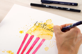 Hand lettering "Keep calm" is written with a black Tombow pen on a popcorn watercolour drawing.