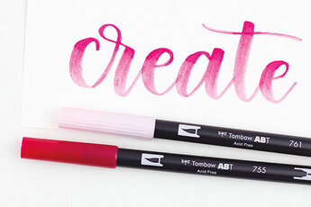 Hand Lettering "Create" mit zwei liegenden ABT Dual Brush Pens in rosa und rot.